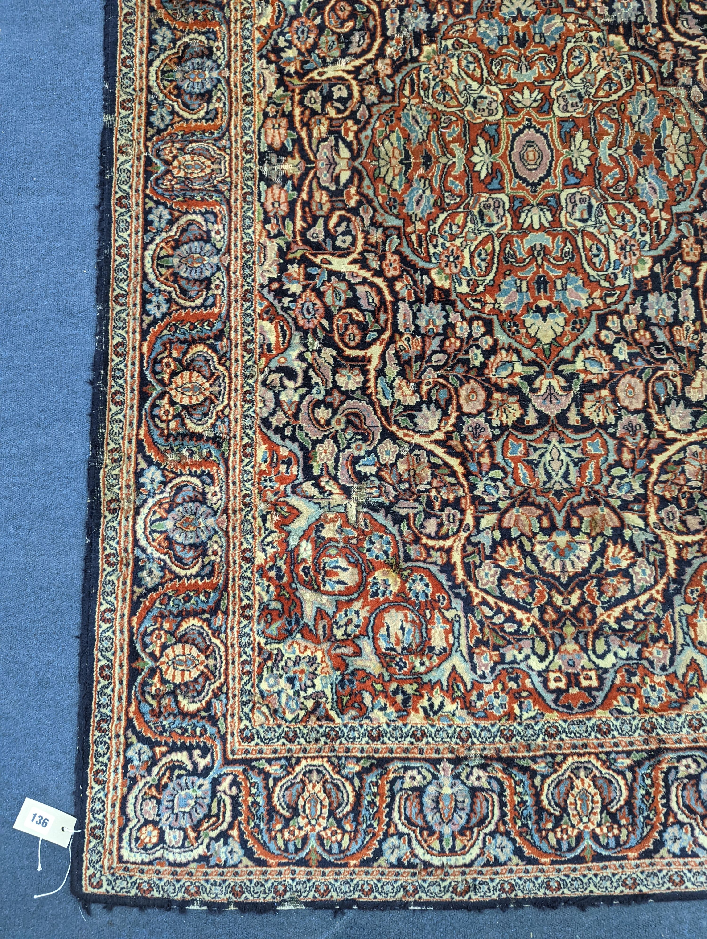 A Kashan blue ground rug, 185x122cm.